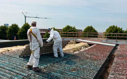 Two people on the roof of a building