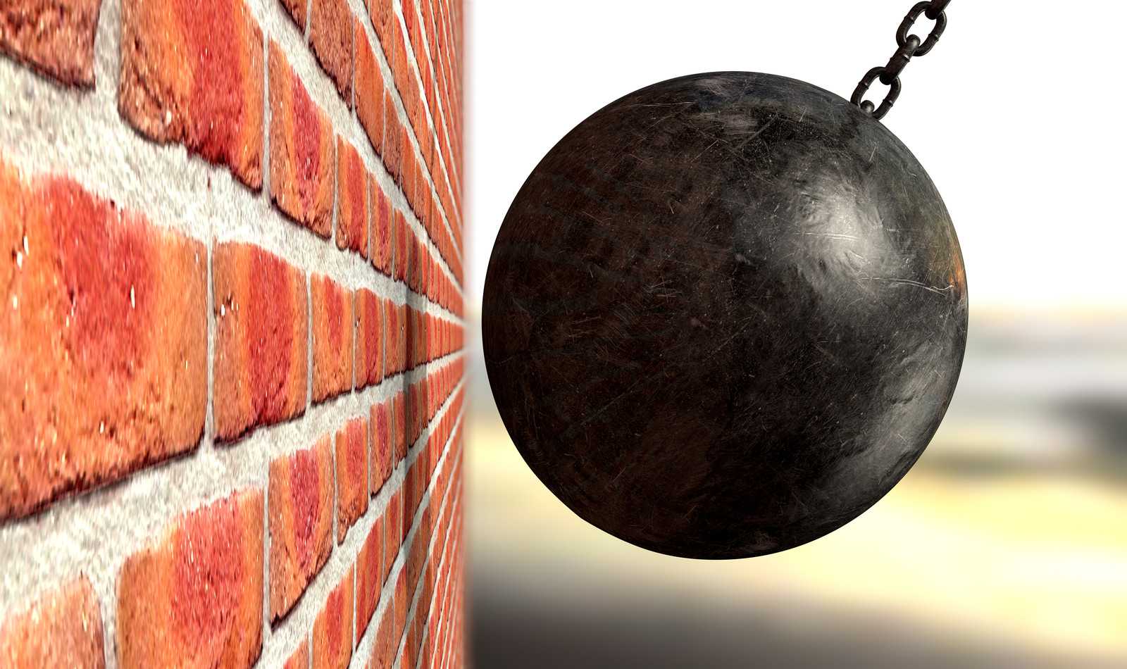 A wrecking ball about to hit brickwall