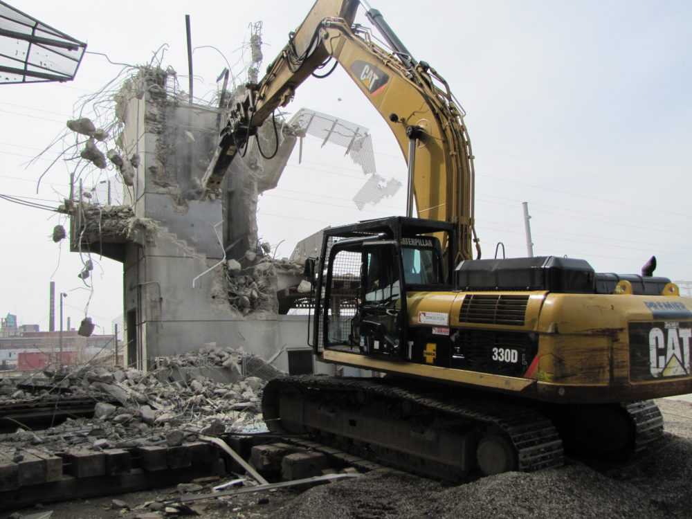 A bulldozer demolishing a building